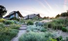 RHS Hyde Hall - Dry Garden, General view showing new Learning Centre/Restaurant in the background